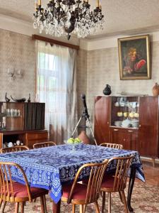 a dining room with a table with chairs and a chandelier at Kolagis Marani in Kolagi
