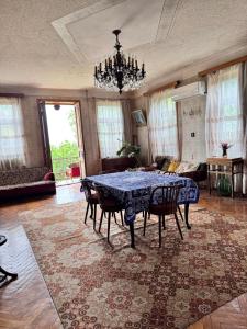a dining room with a blue table and chairs at Kolagis Marani in Kolagi