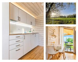 a kitchen with white cabinets and a table and a window at 309 Stylisches Tiny House für Familien in Bleckede