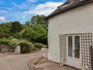 a white building with a door on the side of it at The Studio Cottage in Denbigh +8 photos