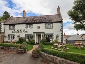 an inn with a picnic table in front of it at The Studio Cottage in Denbigh