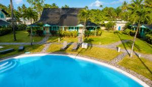 an aerial view of a house with a large swimming pool at Villas Palmar Residence Beachfront Villas & Studios in Las Terrenas