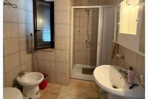 a bathroom with a sink and a toilet and a shower at Panoramic Sea view Deluxe Apartment in Joppolo in Ioppolo