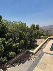 a garden with a pool and some bushes and trees at Luxury Farm Villa with Private Pool in Jerash