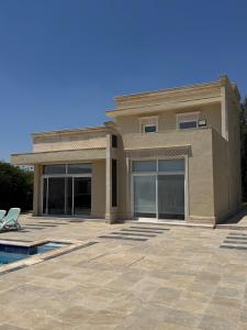 a large house with a patio in front of it at Luxury Farm Villa with Private Pool in Jerash