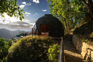 a black dome house on a hill with a view at La Colina Resort SAS in La Vega