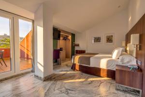 a hotel room with a bed and a balcony at Spa Jardines de Lorca in Lorca +46 photos