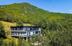 a large house in the middle of a mountain at Resort Anes Drinit in Peje