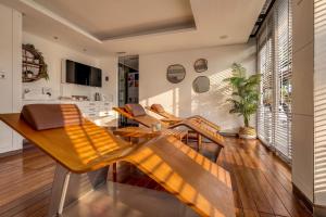 a living room with wooden chairs and a kitchen at Spa Jardines de Lorca in Lorca