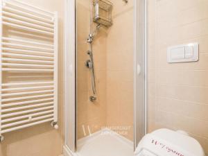 a shower with a glass door in a bathroom at Wanderlust Experience Fronte Porto in Bari +15 photos