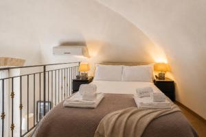 a bedroom with a bed with two towels on it at Wanderlust Experience Fronte Porto in Bari