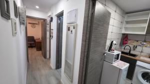 a small kitchen with a sink and a refrigerator at Lovely Holiday in Alicante +9 photos
