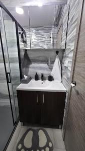 a bathroom with a white sink and a shower at Lovely Holiday in Alicante