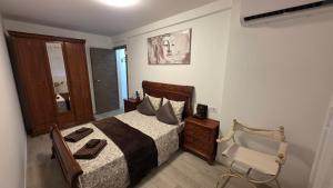 a bedroom with a bed and a chair in it at Lovely Holiday in Alicante