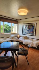 a room with several beds and a table and chairs at Mia Hotel in Orissaare