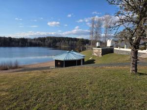 a gazebo in a field next to a lake at Hotel Lahnajärvi in Lahnajärvenkylä
