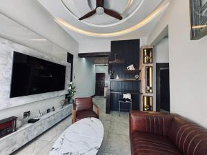 a living room with a couch and a flat screen tv at Big Mo Bev and Grill in Middelburg