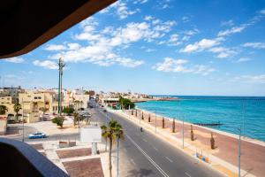 a view of a street and the ocean in a city at Dakhla Sur Mer Hôtel in Dakhla