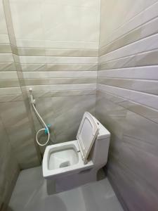 a bathroom with a toilet in a stall at Samrat Hotel in Sonīpat