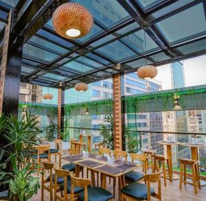 a restaurant with tables and chairs and glass ceilings at Dhaka Unique Regency in Dhaka