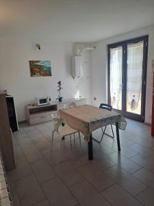 a kitchen with a table and chairs in a room at Casa Levante in Brugnato +3 photos