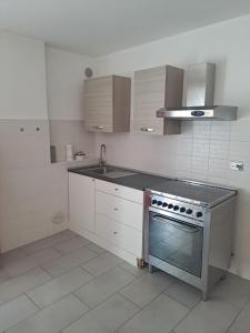 a kitchen with a stove and a sink at Casa Levante in Brugnato