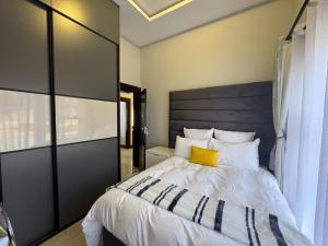 a bedroom with a large bed with a wooden headboard at Big Mo Bev and Grill in Middelburg