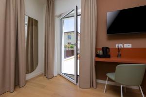 a room with a sliding glass door with a window at Borgo di Lazise - Adults friendly in Lazise