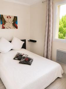 a white bed in a room with a window at villa plaisirs in Saint Paul de Vence +35 photos