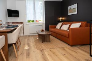 a living room with a couch and a table at La Suite Cacao in Saint-Rambert-dʼAlbon