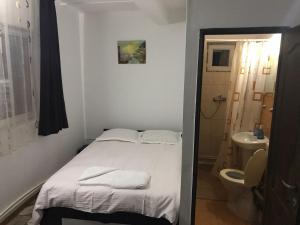 a small bedroom with a bed and a toilet at Pensiunea Marcello in Iaşi +36 photos
