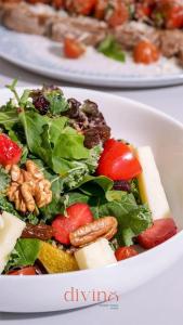 a salad with fruit and vegetables in a white bowl at Serail Hotel in Ehden