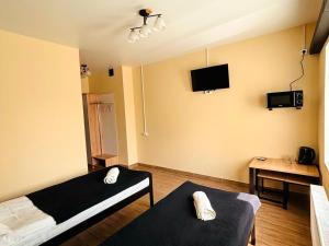 a room with a bed and a tv on the wall at Shpola Central Hotel in Shpola