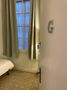 a bedroom with a window and a bed with a door at Des Artistes in Barcelona +39 photos