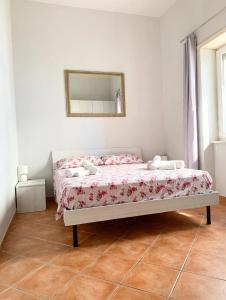 a bedroom with a bed with a mirror on the wall at Casa Vacanze Formia in Formia