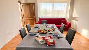 a dining room with a table and a red couch at Casa Vacanze Formia in Formia