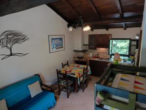 a living room with a blue couch and a table at Locanda del Ponte B&B in Balsorano Vecchio
