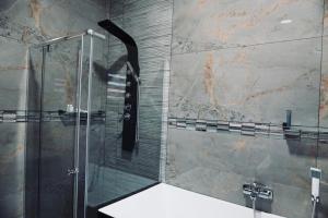 a bathroom with a shower with a glass door at Big Mo Bev and Grill in Middelburg +48 photos