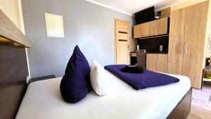 a bedroom with a large bed with blue pillows at Pension Schwarze Pumpe in Spremberg