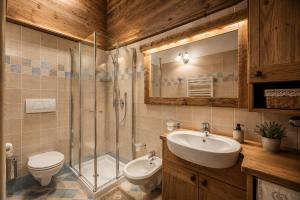 a bathroom with a toilet and a sink and a shower at Cesa Linda by AMA Val di Fassa in Campitello di Fassa