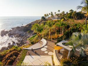 an aerial view of a beach with palm trees and the ocean at Casa de la Luna in Puerto Escondido