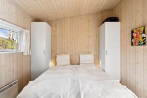 a bedroom with a large white bed in a room at Luxury Lakeside Retreat in Ringsted