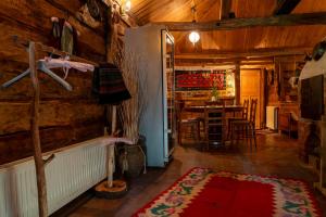 a living room with a red rug in a wooden house at Etno Kuca Bajka in Mataruška Banja