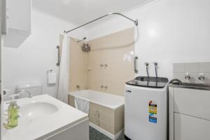 a white bathroom with a sink and a tub at Kings Corner in Sandy Bay +28 photos