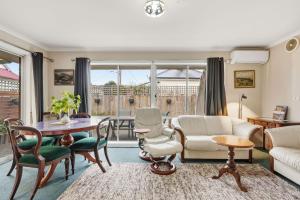 a living room with a table and chairs at Kings Corner in Sandy Bay