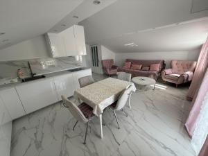 a kitchen and living room with a table and chairs at Apartments Mare in Banjol