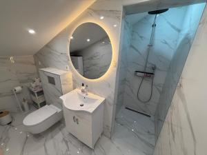 a bathroom with a sink and a toilet and a mirror at Apartments Mare in Banjol +71 photos