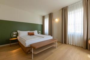 a bedroom with a bed and a green wall at Borgo di Lazise - Adults friendly in Lazise