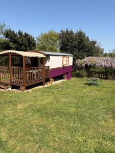 a train car with a gazebo in a yard at Bastide de montchamp in Malataverne +7 photos