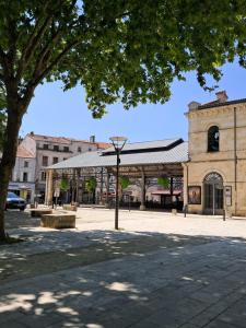 a building with a pavilion in the middle of a street at Chemin du vieux Puits in Surgères